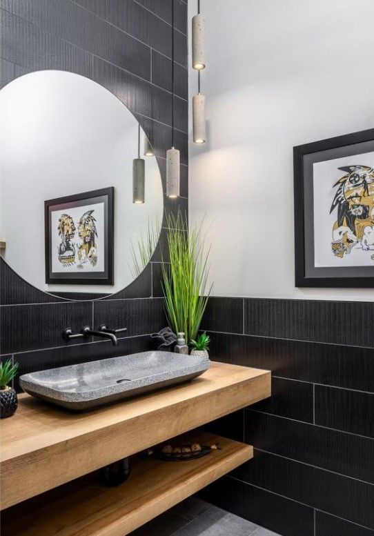 Une salle de bain avec un lavabo, un miroir et un tableau au mur.
