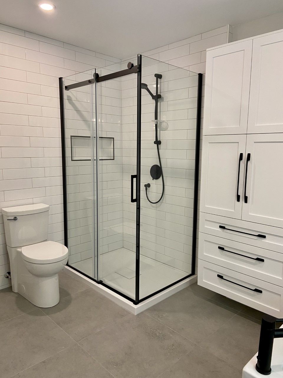 Une salle de bain avec WC, douche et placards.
