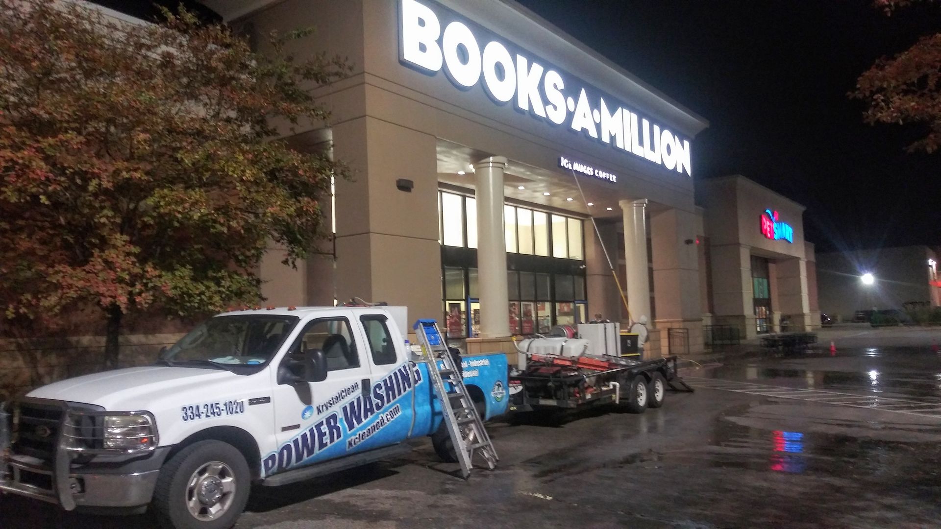 A white truck is parked in front of a book store