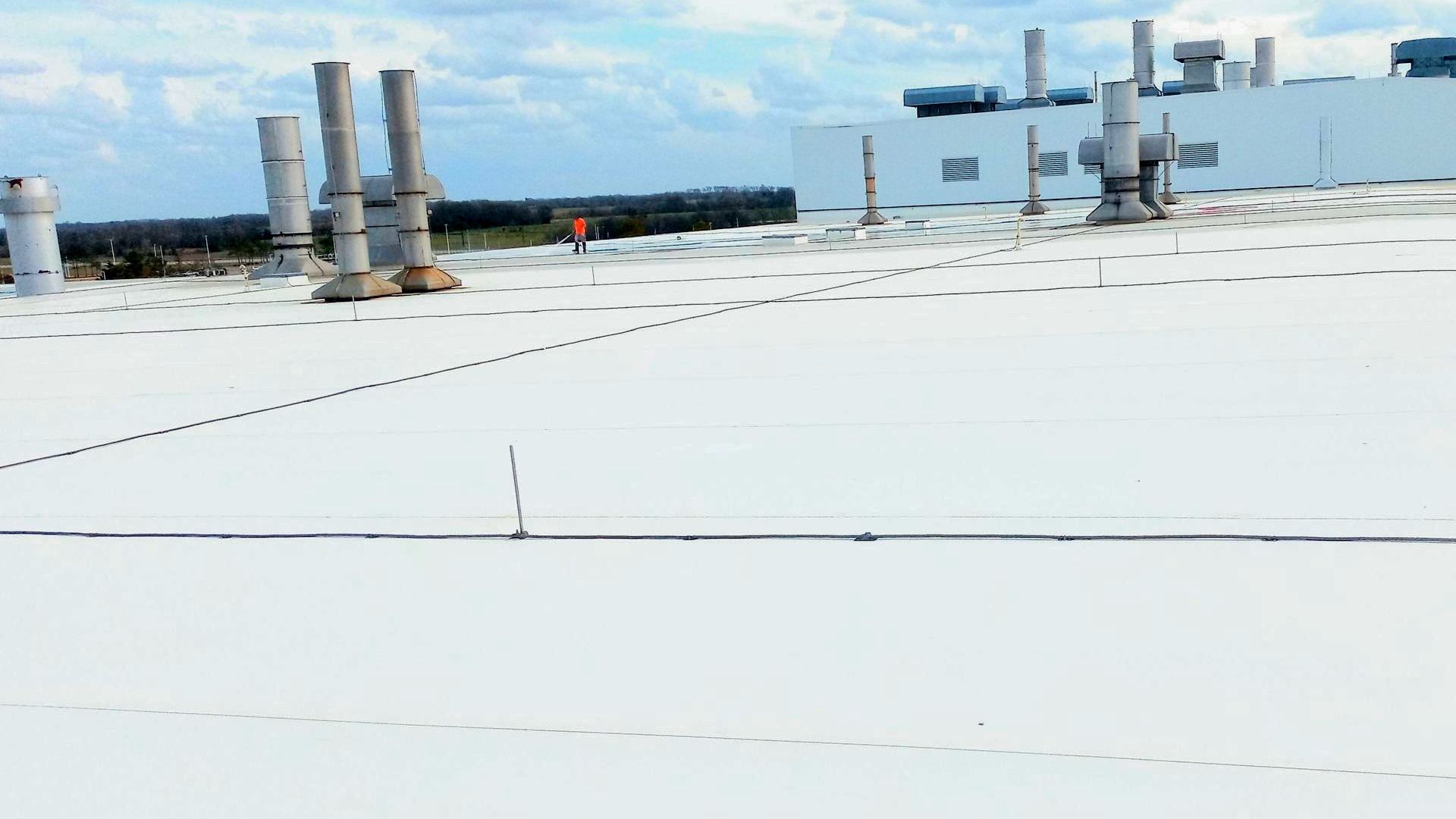 A large white roof with a lot of chimneys on it.