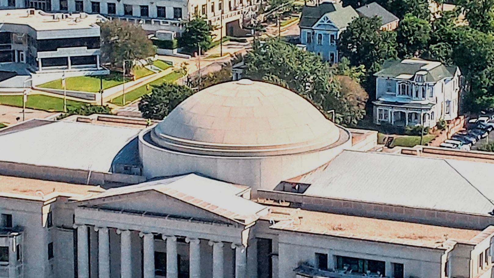 An aerial view of a large building with a dome on top
