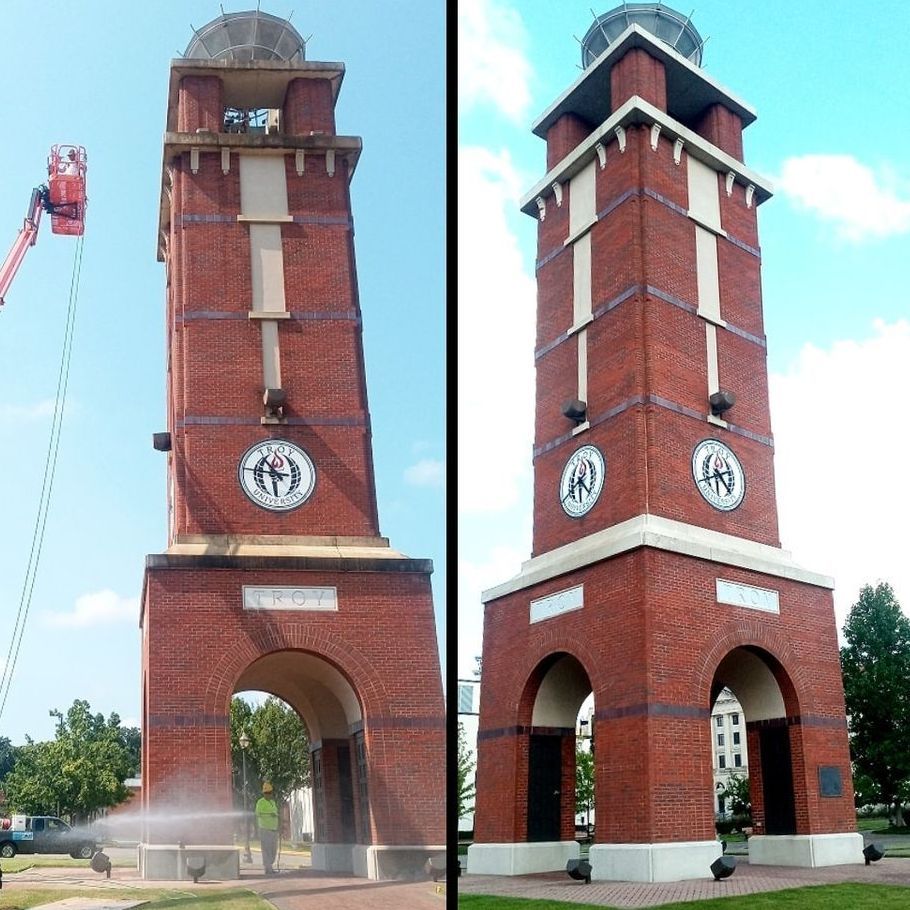 a brick clock tower is being cleaned by krystal clean