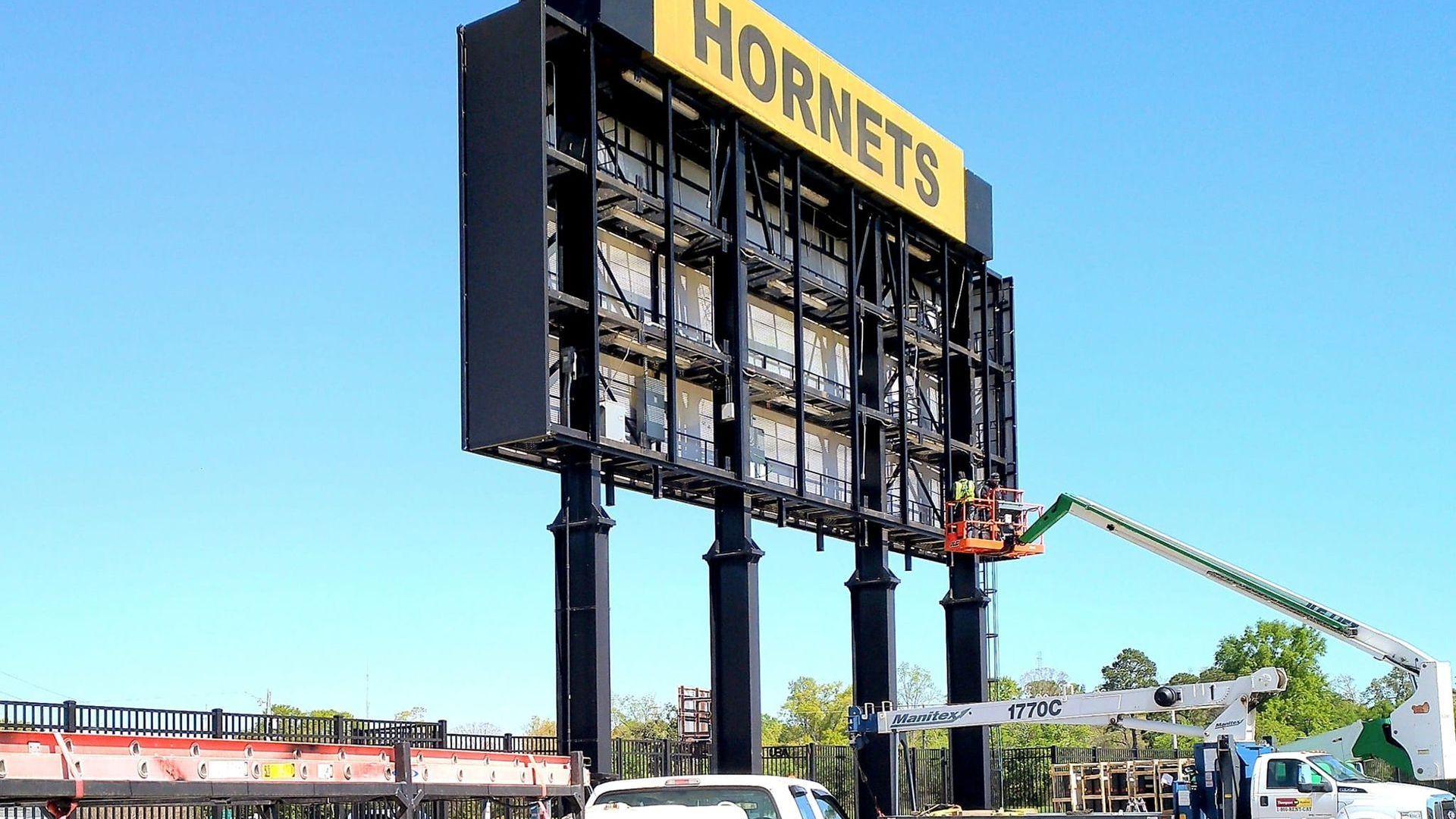 A large billboard for the hornets is being built.