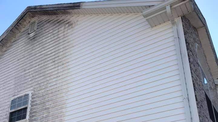 The side of a house with a lot of mold on it.