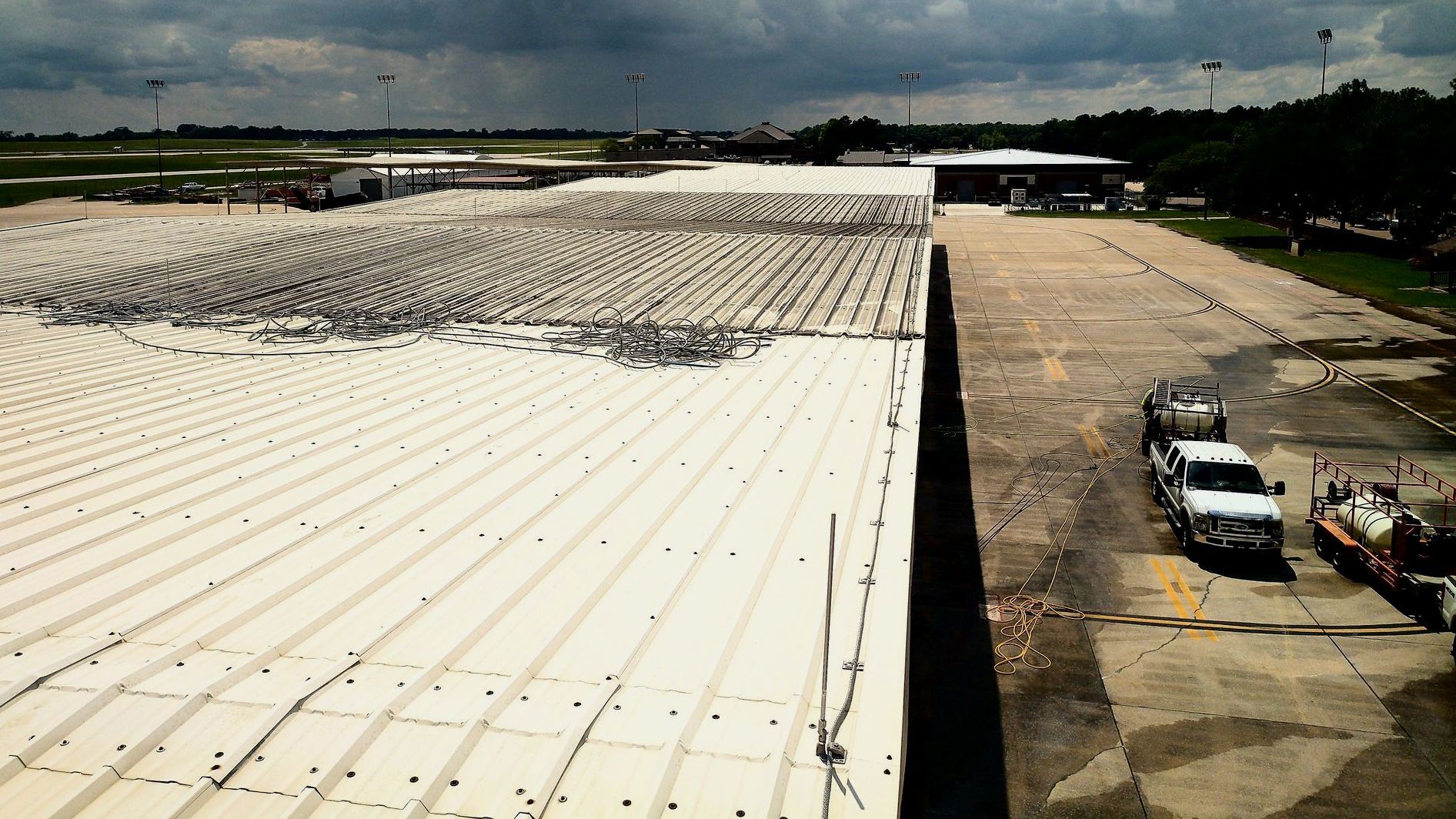 A large white roof with trucks parked on it