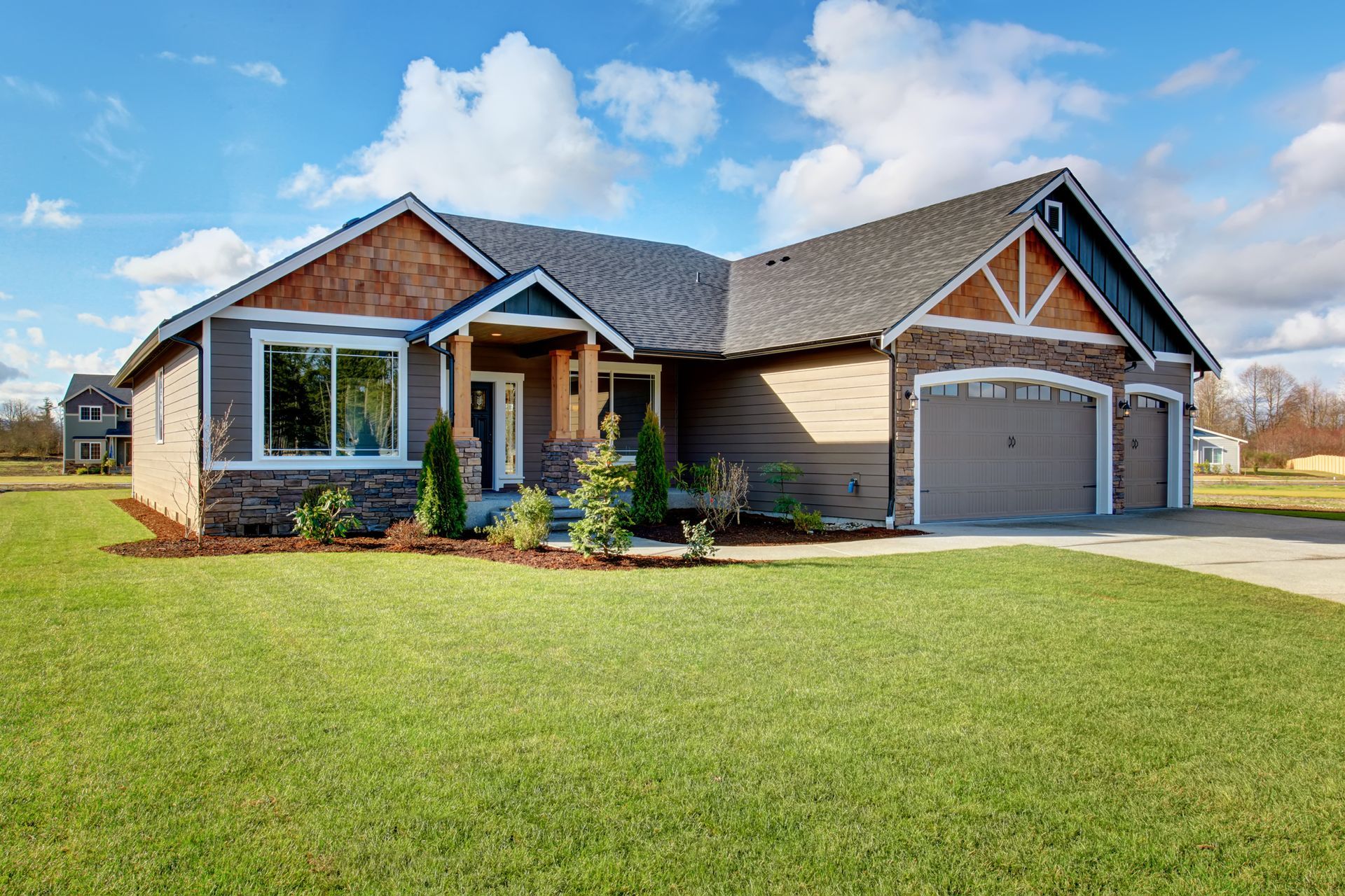 A large house with a lush green lawn in front of it.