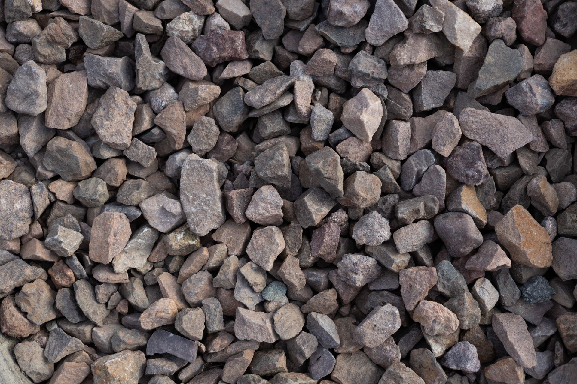Pile of small gray and brown rocks filling the frame.