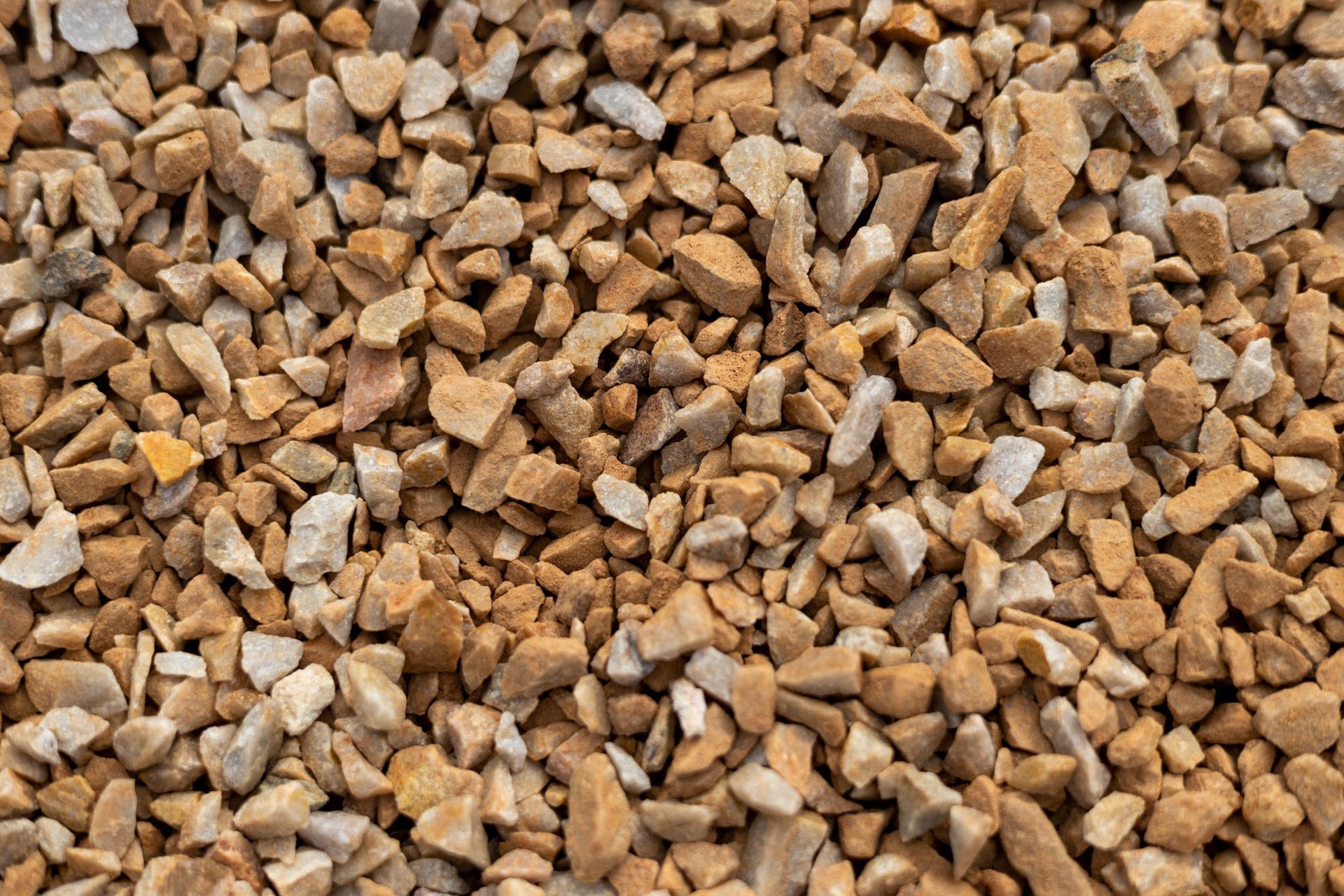 Close-up of small tan and brown gravel stones filling the frame