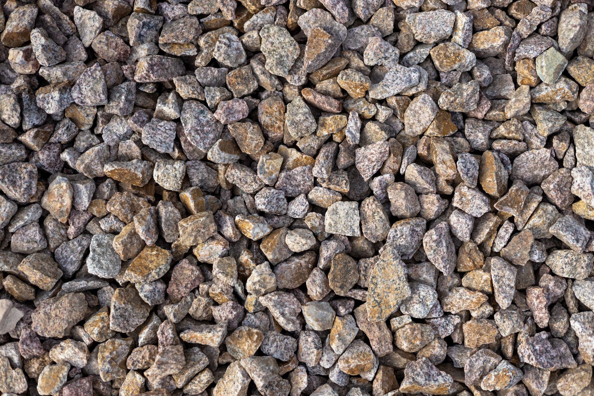 Close-up of small gray and tan gravel stones filling the frame
