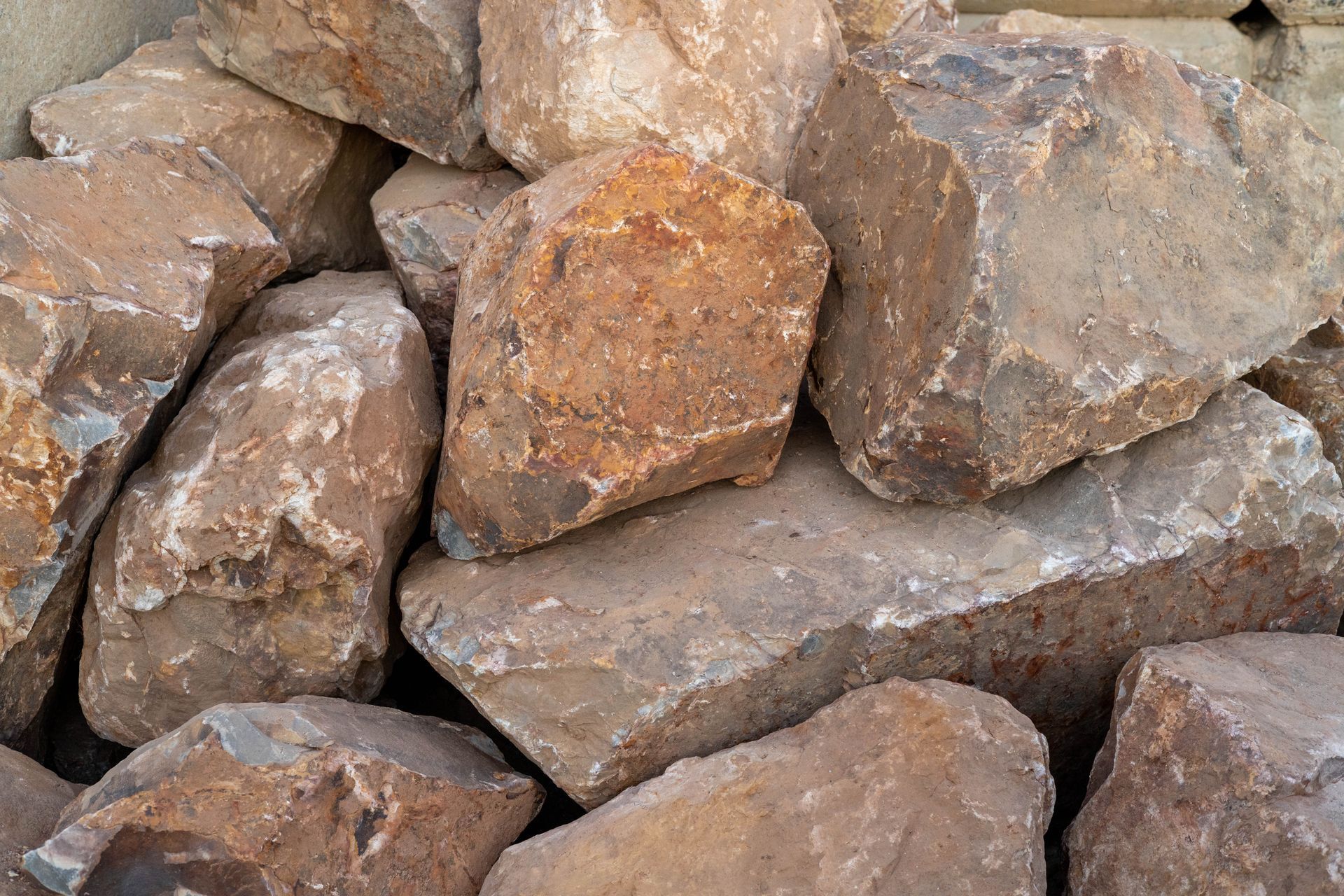 Pile of rough, tan and brown rocks stacked closely together