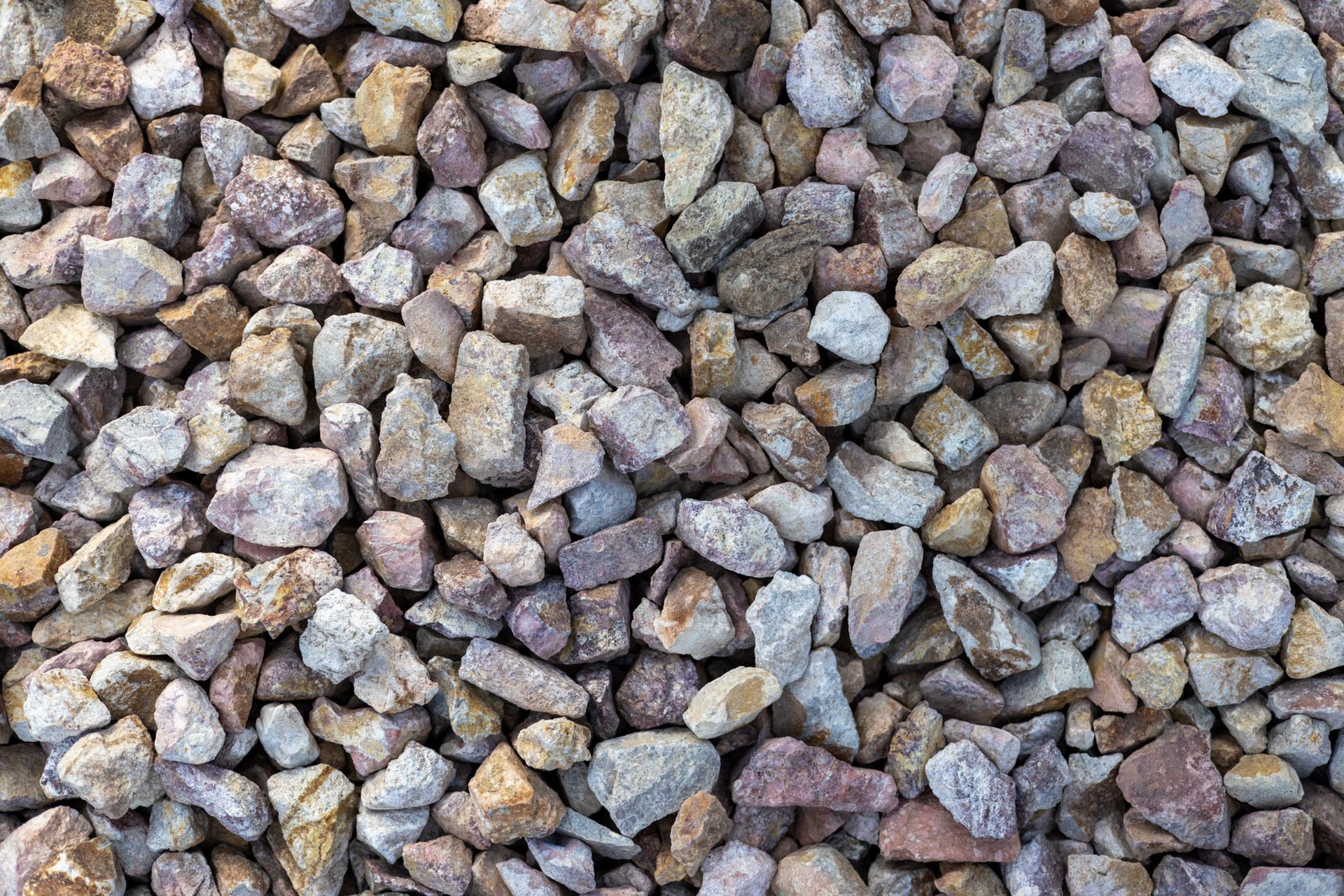Close-up of small gray and tan gravel stones filling the frame