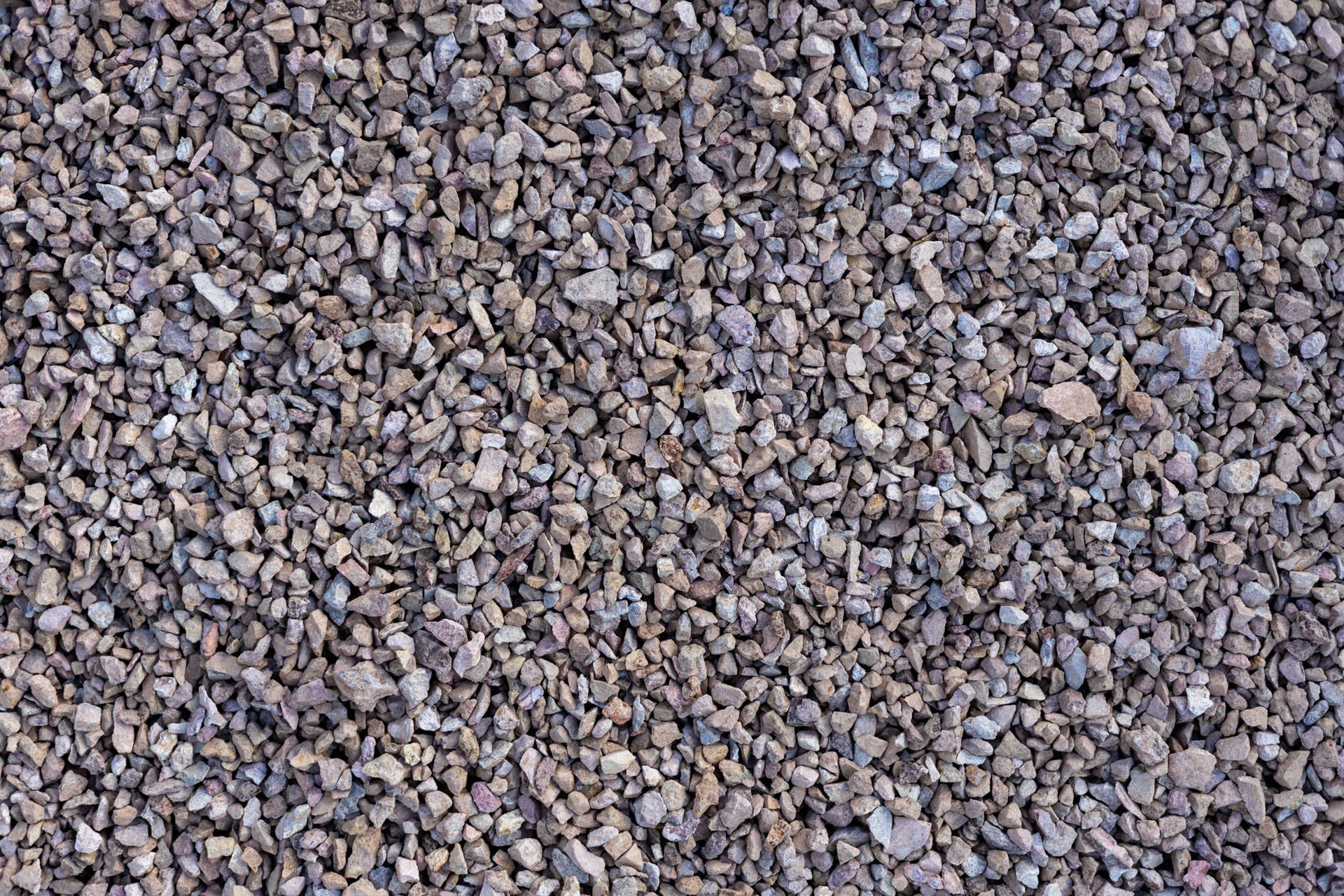 Close-up of small gray and tan gravel stones filling the frame