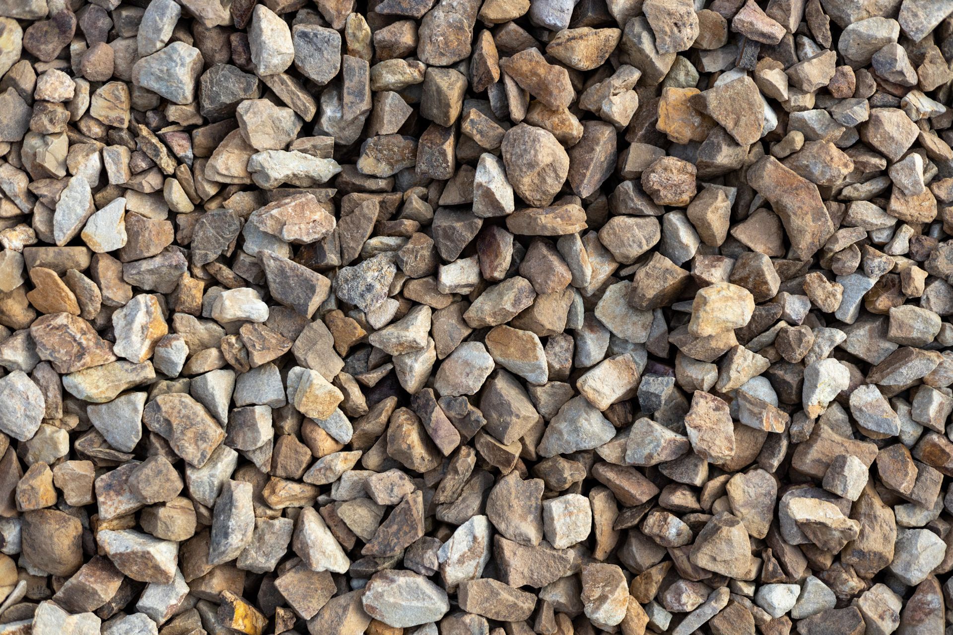 Pile of small brown and gray gravel stones filling the frame