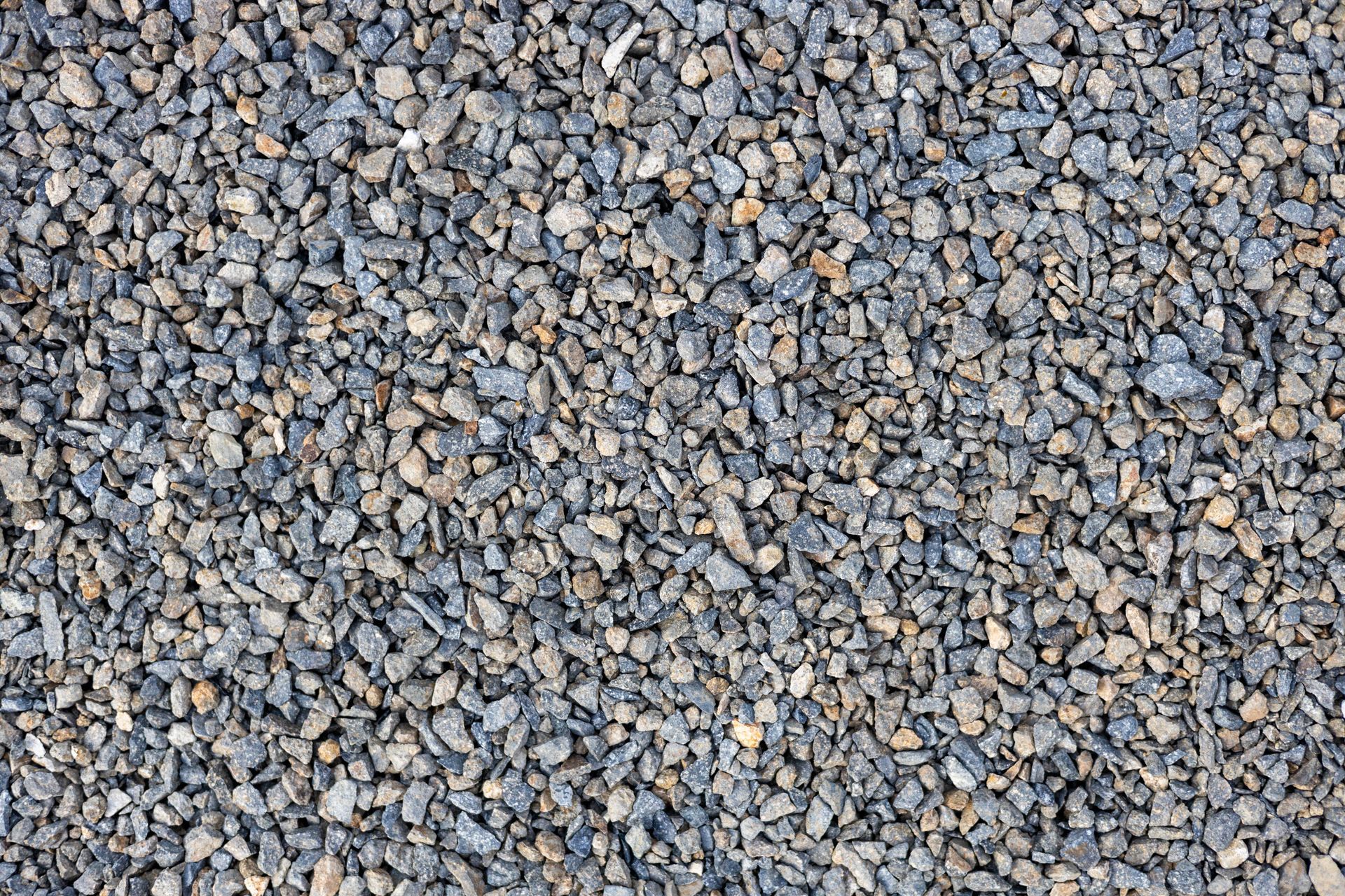 Close-up of small gray and tan gravel stones covering the ground.