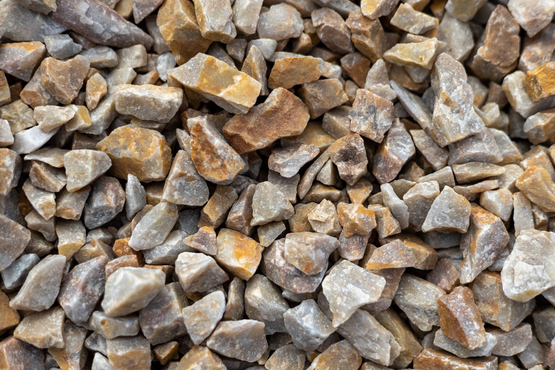 Pile of small gray and tan rocks filling the frame