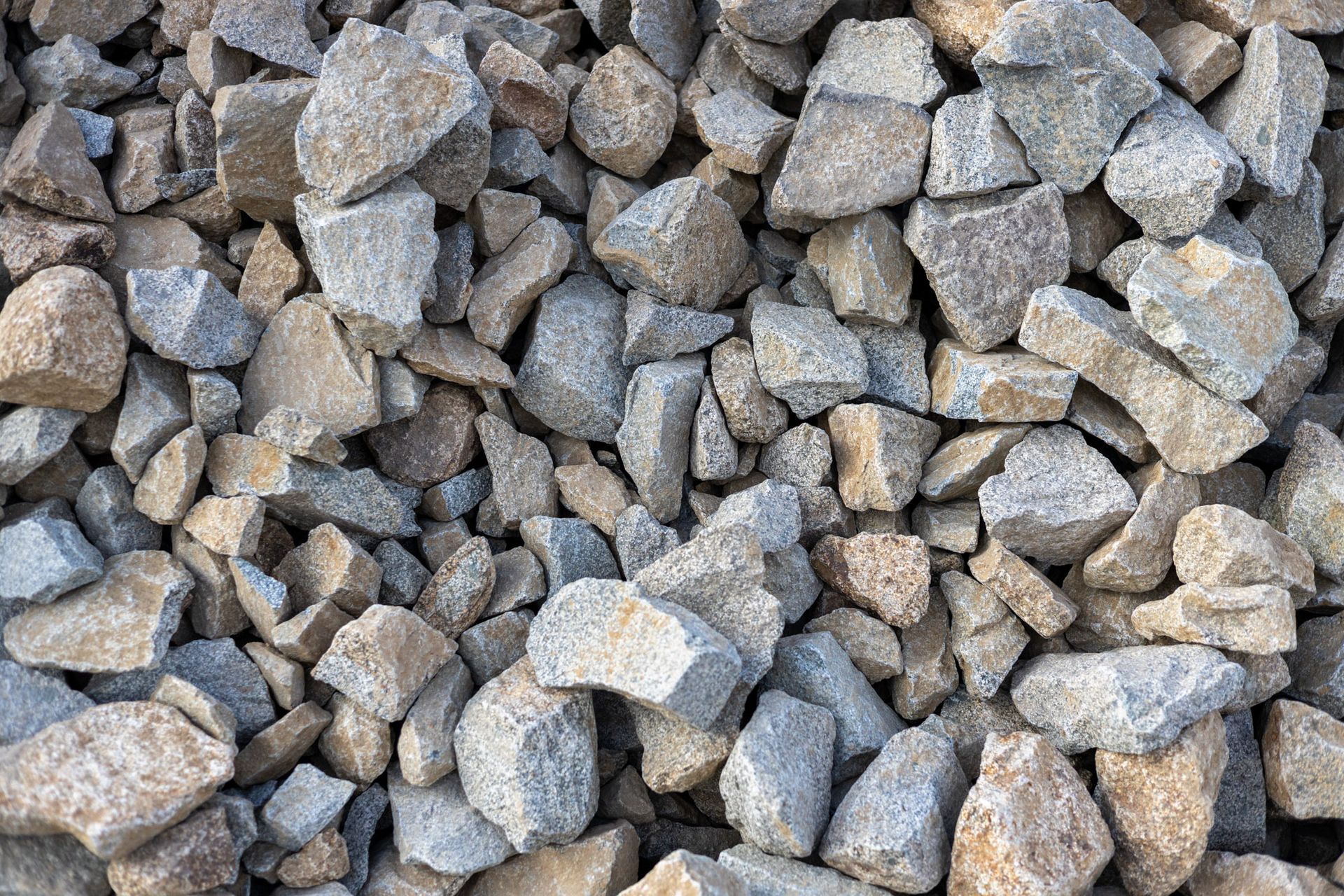 Pile of gray and tan rocks and gravel, filling the frame