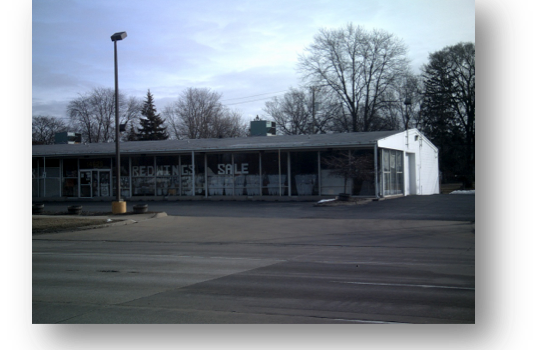 A Picture Of A Building With A Parking Lot In Front Of It