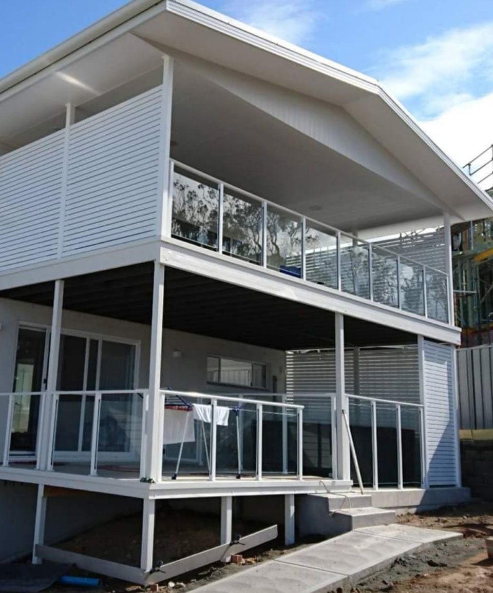White House With A Large Balcony On The Second Floor And Glass Fence — Decorative Aluminium Works In Cardiff, NSW