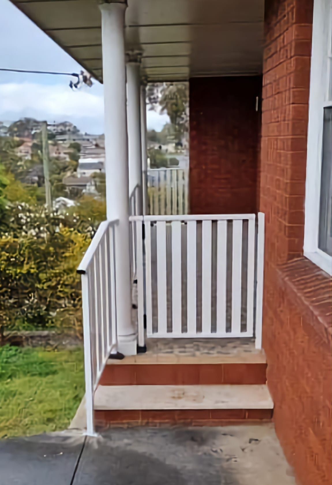 Brick Building With A White Railing And Stairs — Decorative Aluminium Works In Newcastle, NSW