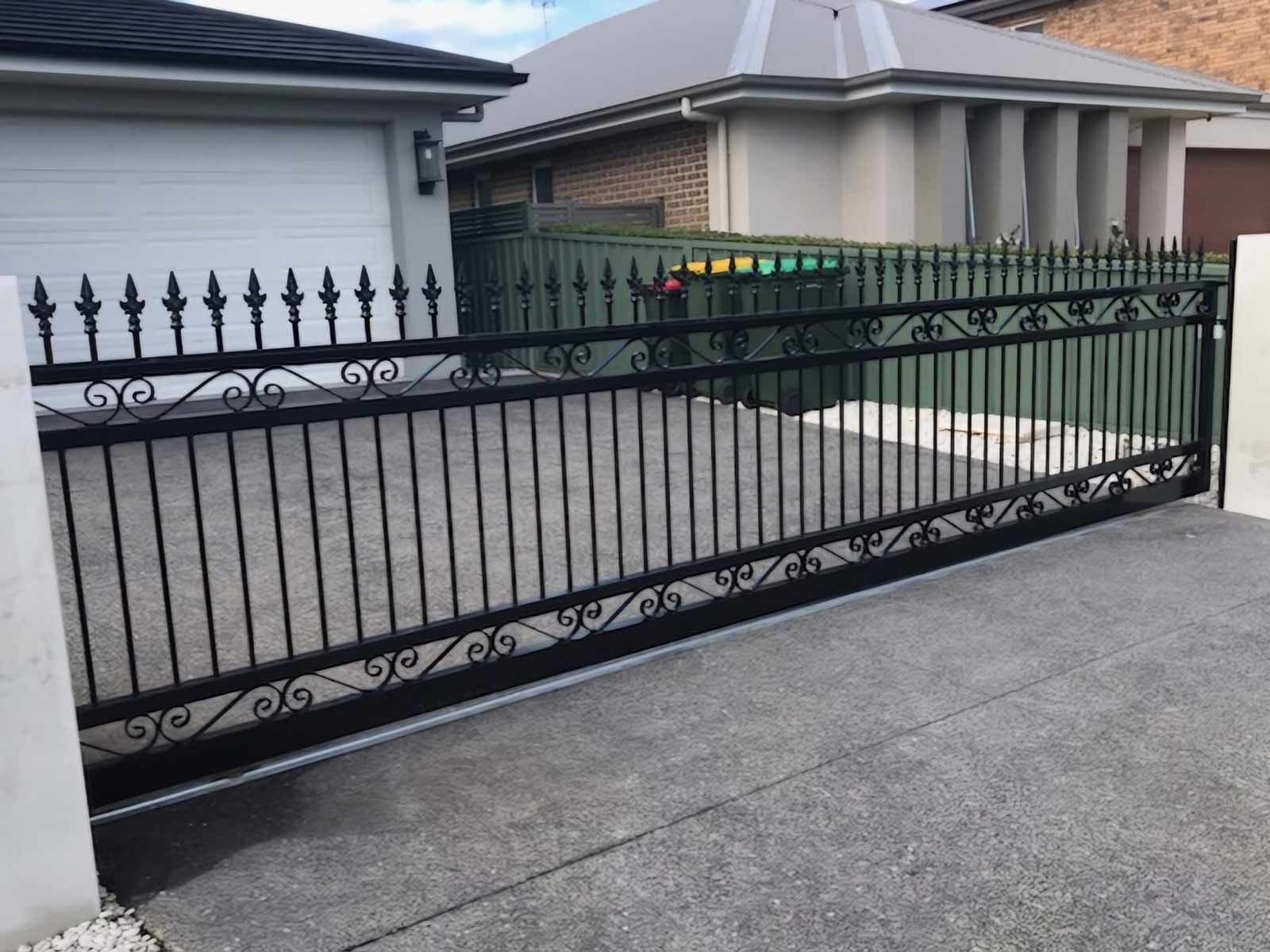 Black Aluminium Sliding Gate In Front Of A House — Decorative Aluminium Works In Cardiff, NSW