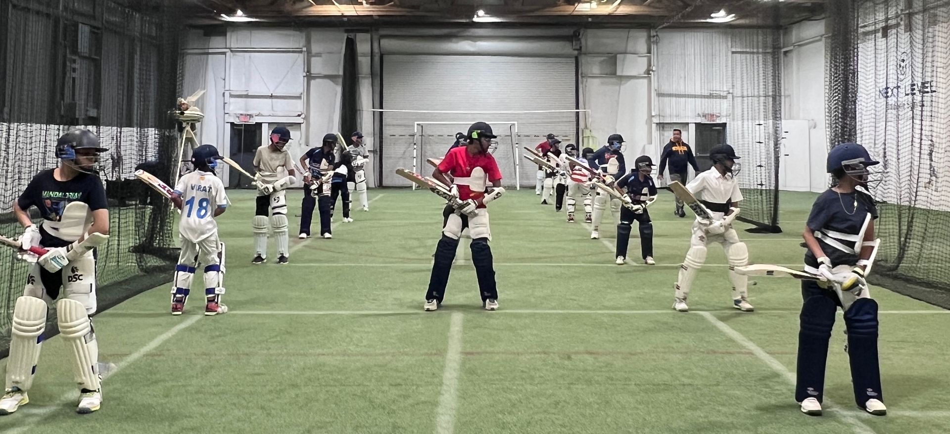 A person is kicking a soccer ball on a field.