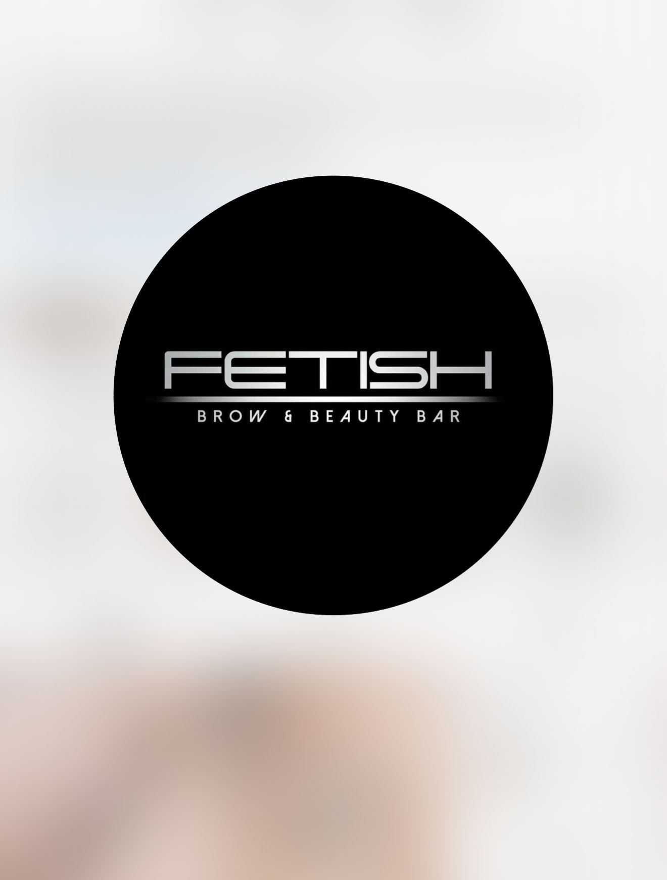 A black circle with the words fetish brow beauty bar on it