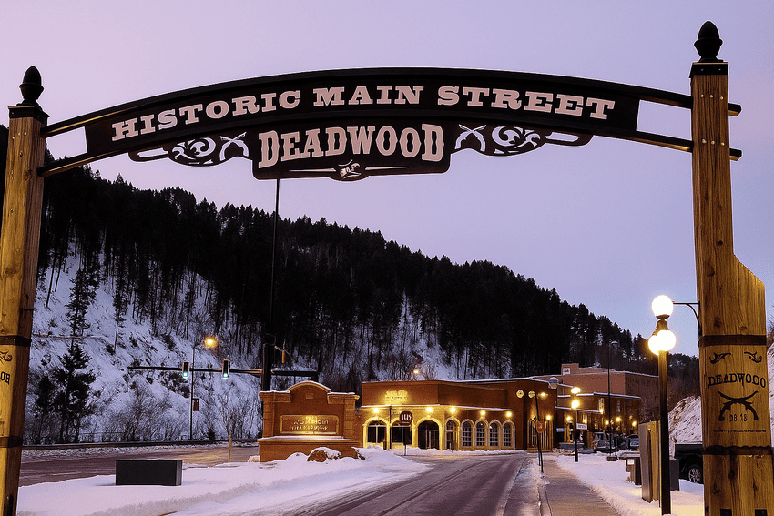 Historic Main Street Deadwood sign and homes in the background