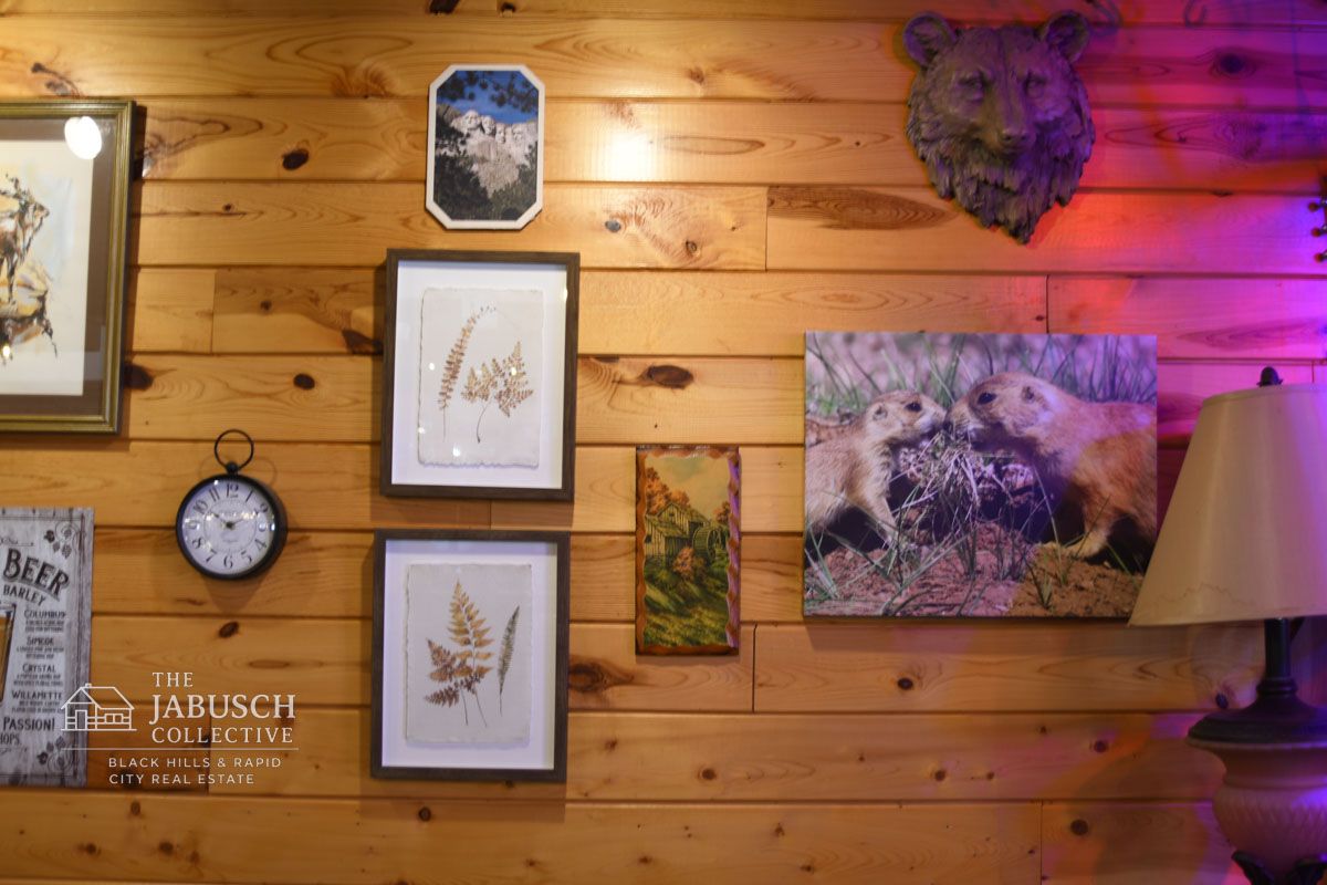 Wooden wall with various framed artwork and bear head a Prairie Dog Taproom