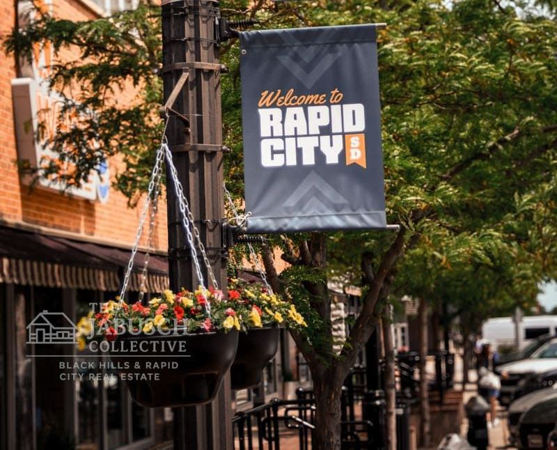 A sign on a pole that says Welcome to Rapid City
