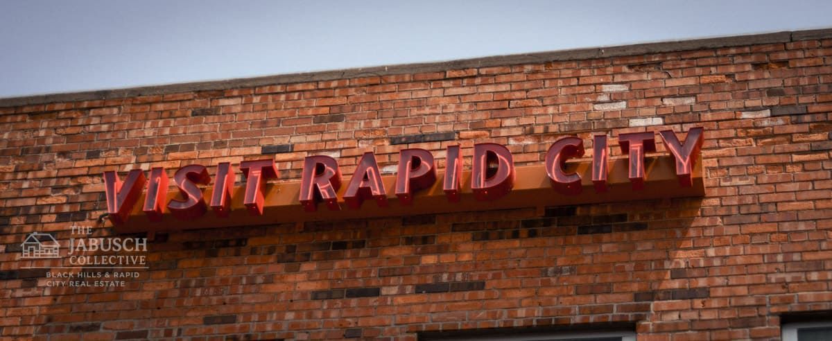 Downtown visit Rapid City sign on brick building