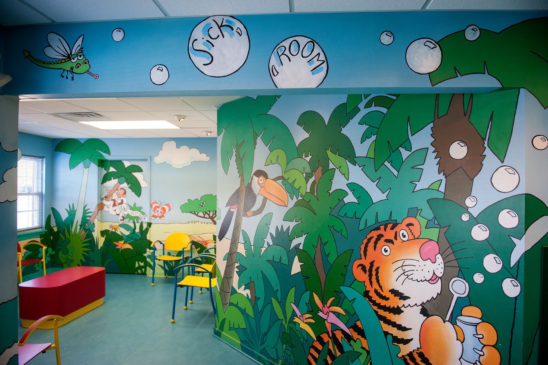 Sick waiting area with colorful mural on the walls at a pediatricians office