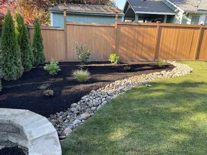 A fence with a view of a lake behind it.