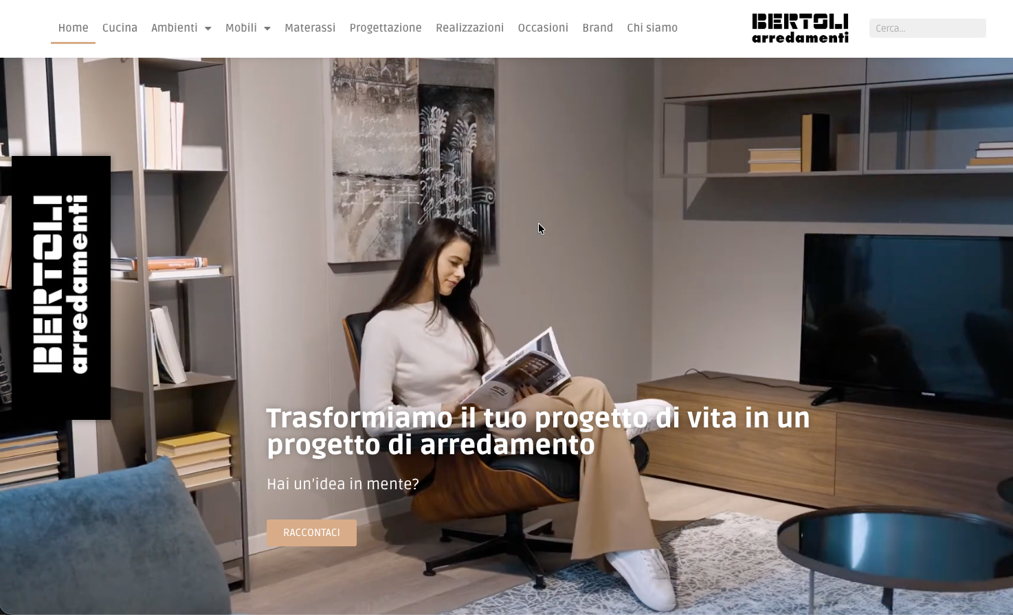 Donna seduta, che legge, in un soggiorno moderno, showroom di mobili Bertoli arredamenti.
