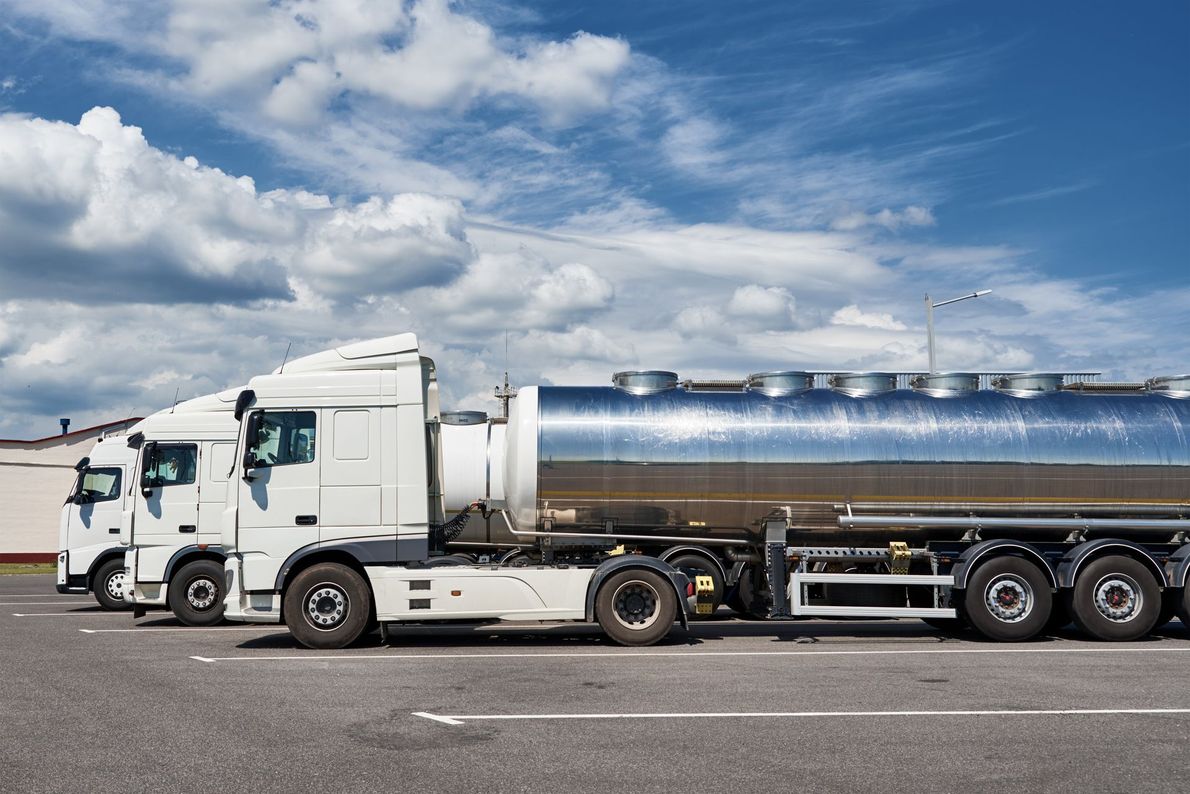 DOT-compliant tanker trucks transporting bulk liquid industrial waste
