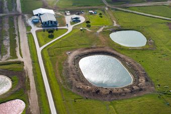 Aerial view of industrial pond and lagoon cleanout site during dewatering and sludge removal