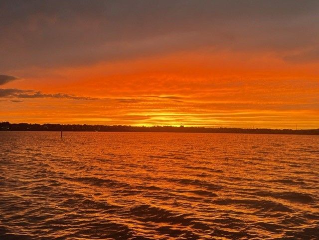 The sun is setting over a body of water.