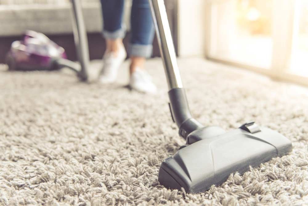 Close Up Image Of Vacuum Cleaner While Cleaning A Carpet