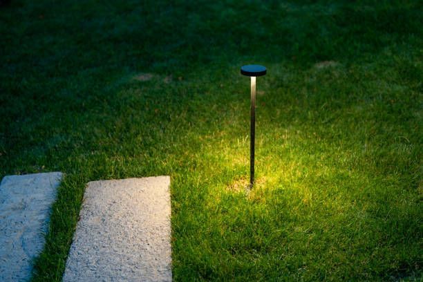Close view of a landscaping light in a lawn at night.