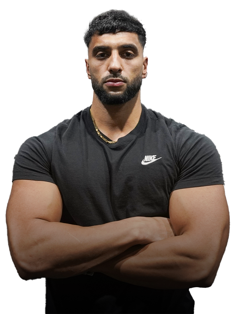 Manni kumar  with a beard wearing a black nike shirt is standing with his arms crossed.