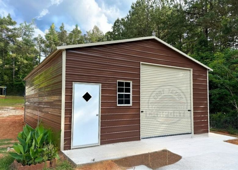 A one car garage brown siding, beige trim and a beige roll up door.  The building also has a walk in door and window.