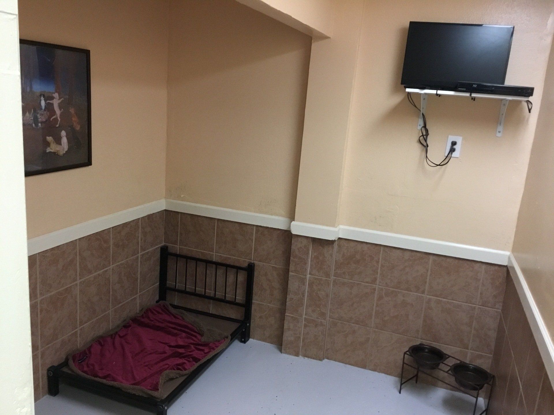 tan room with bed and tv
