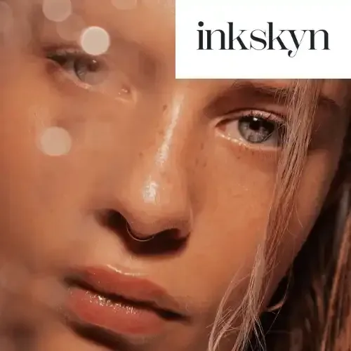 A close up of a woman 's face with a logo in the corner.