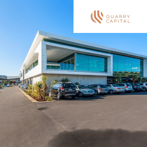 a large building with a lot of cars parked in front of it .