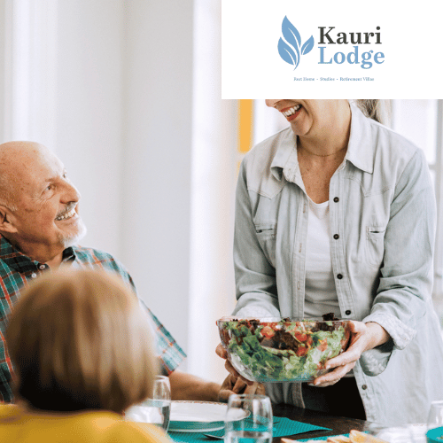 a woman is serving a salad to a group of people at a table .