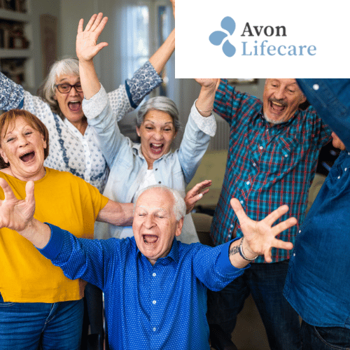 a group of people with their arms in the air with the avon lifecare logo in the background