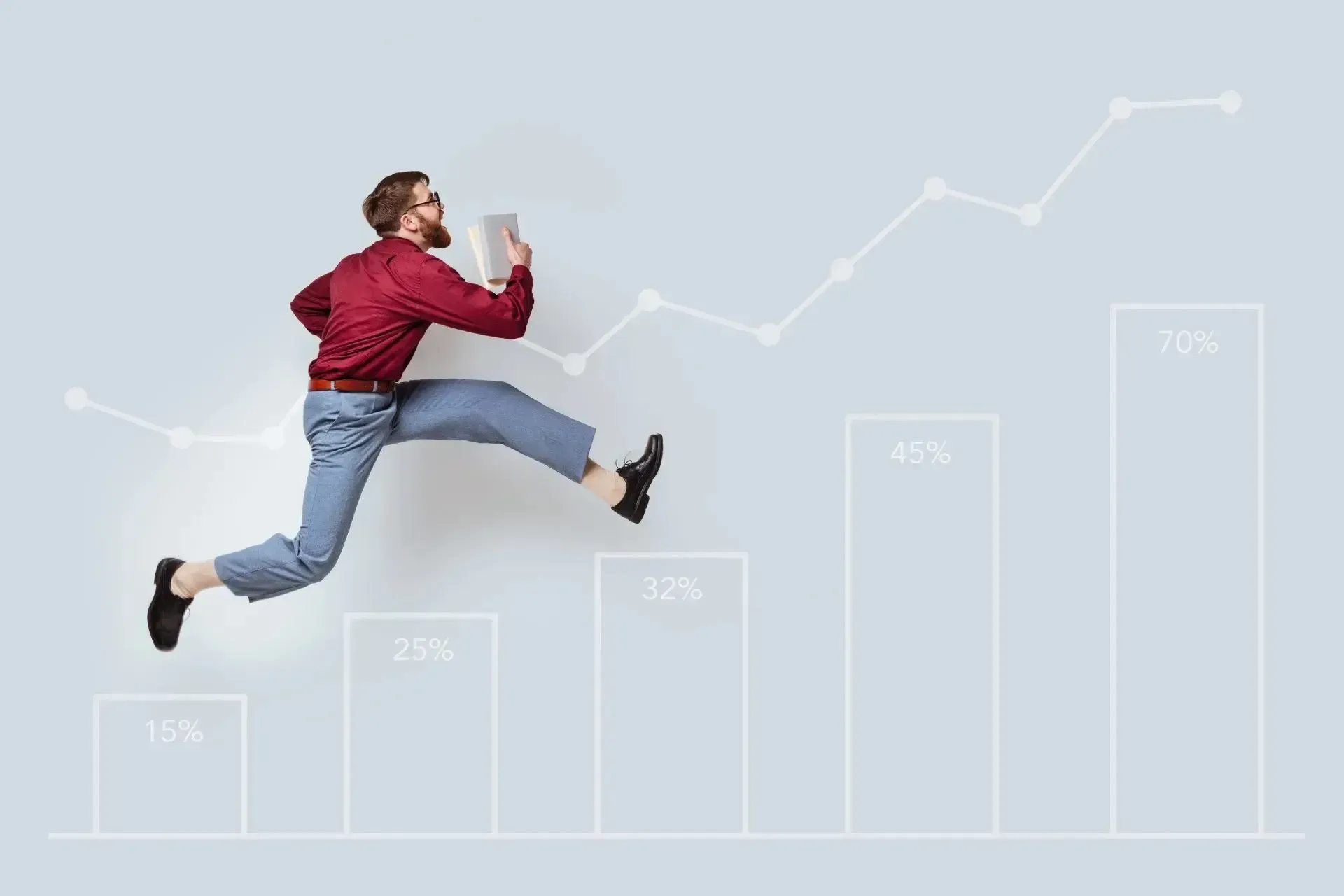 Man in red shirt leaps up a bar graph showing financial growth.