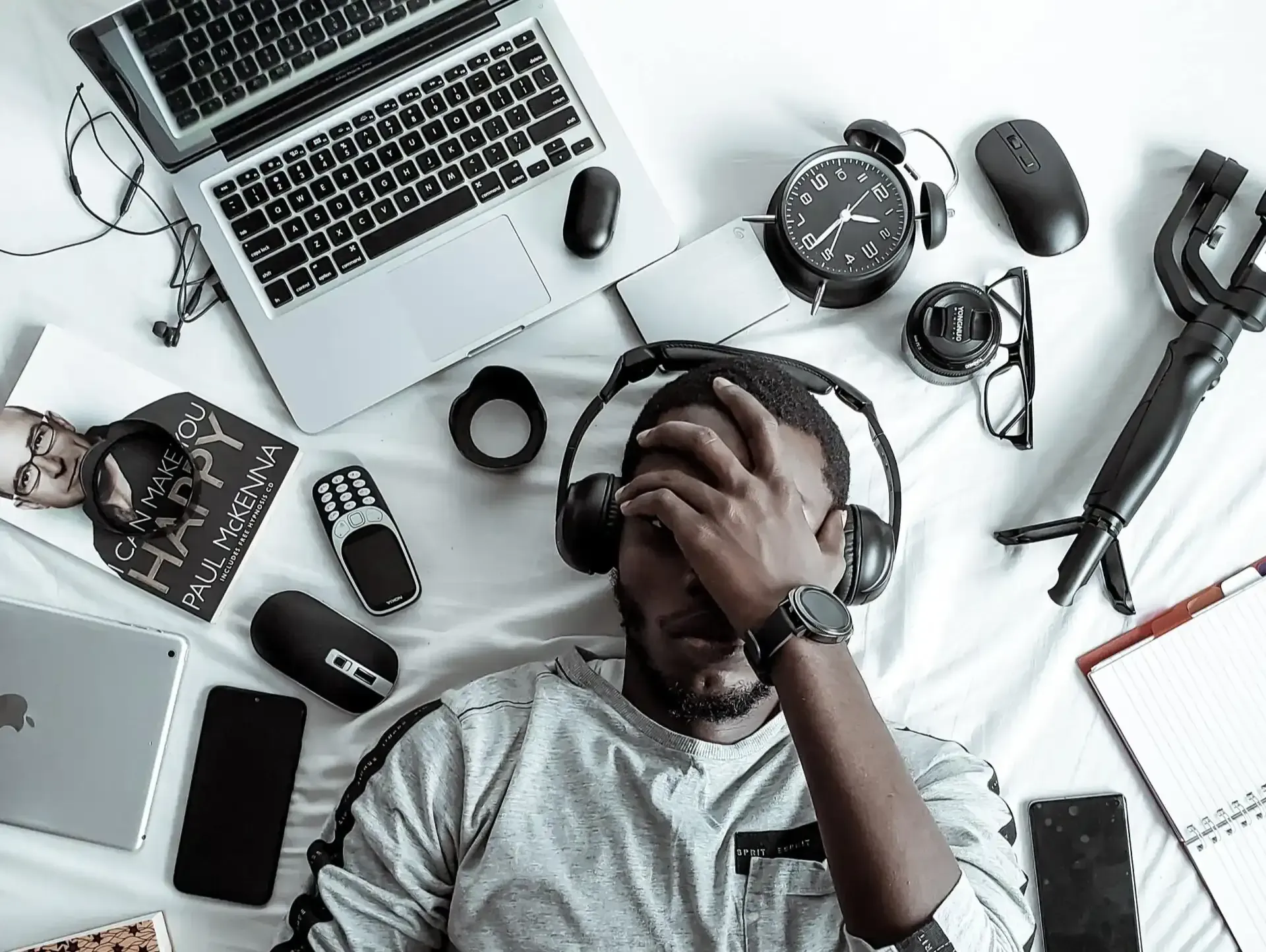 Man frustrated with technology devices around him