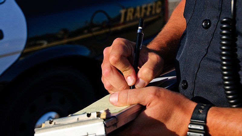 police officer writing on notepad