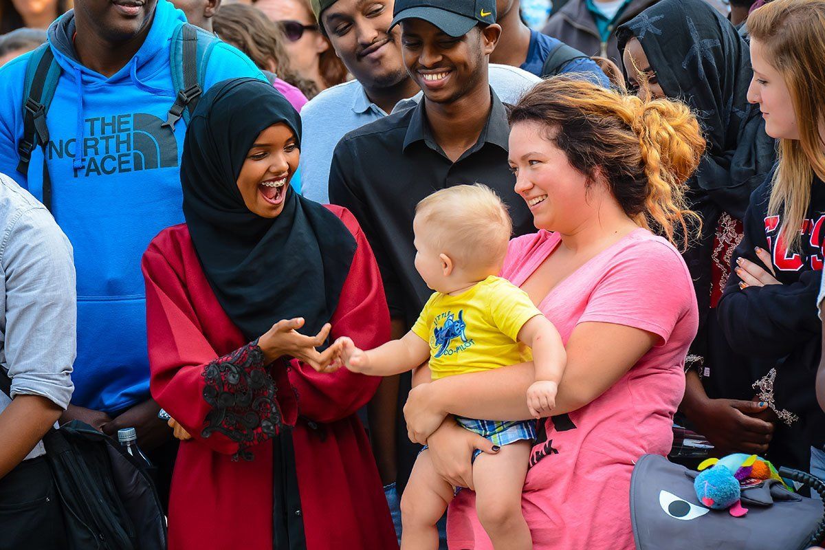 Two women and a baby smiling at eachother