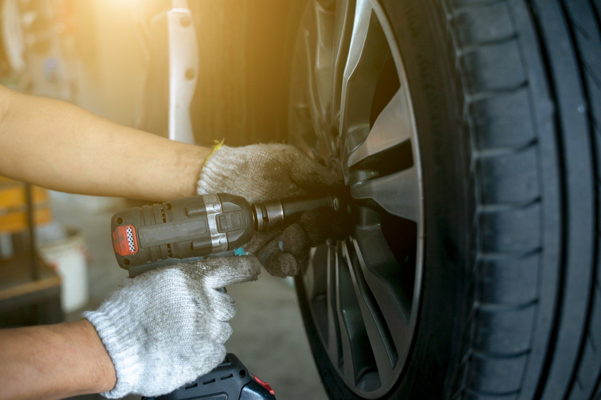 Detail Image of Mechanic Hands with a Tool, Changing the Tyre | Helensvale, Qld | Ashtons Removals